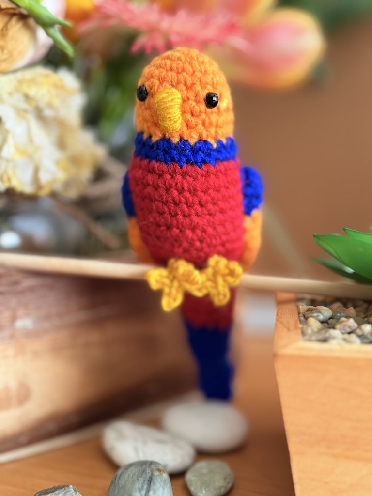 handmade crochet cockatiel bird with bright colourful feathers