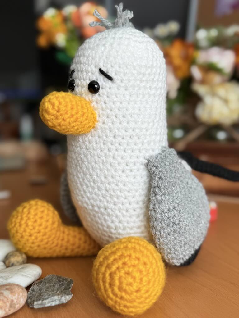 handmade crochet seagull with yellow beak, white wings, and friendly eyes