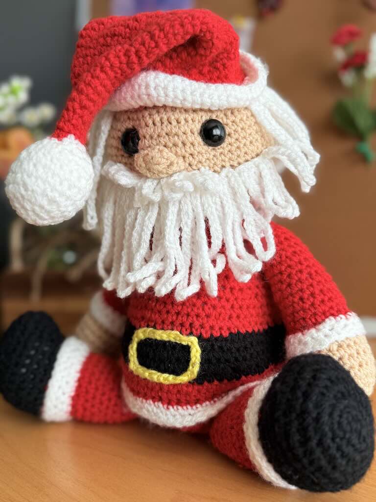handmade crochet Santa Claus with red suit, hat, and white beard