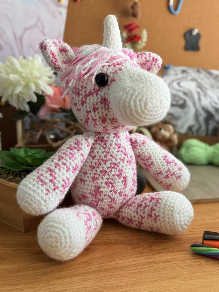 handmade crochet unicorn with colorful mane and white horn