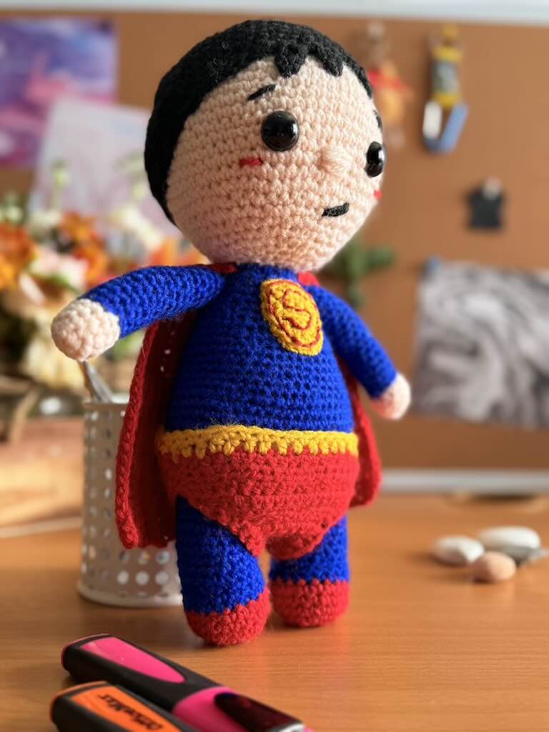 handmade crochet superhero toy dressed as Superman with cape and emblem