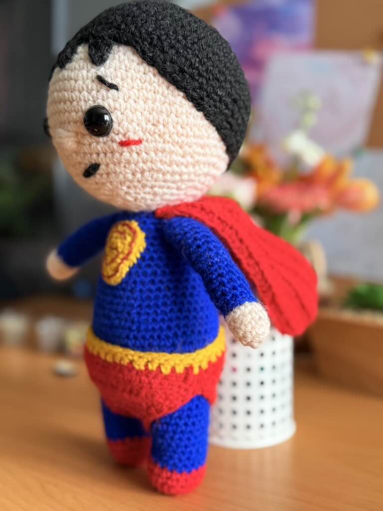 handmade crochet superhero toy dressed as Superman with cape and emblem