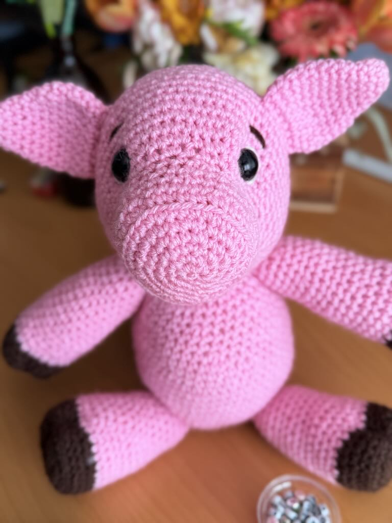 cute handmade crochet pink piggy with round body and friendly face