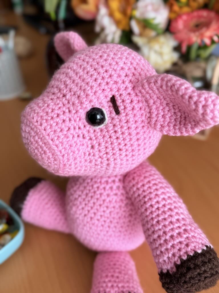 cute handmade crochet pink piggy with round body and friendly face