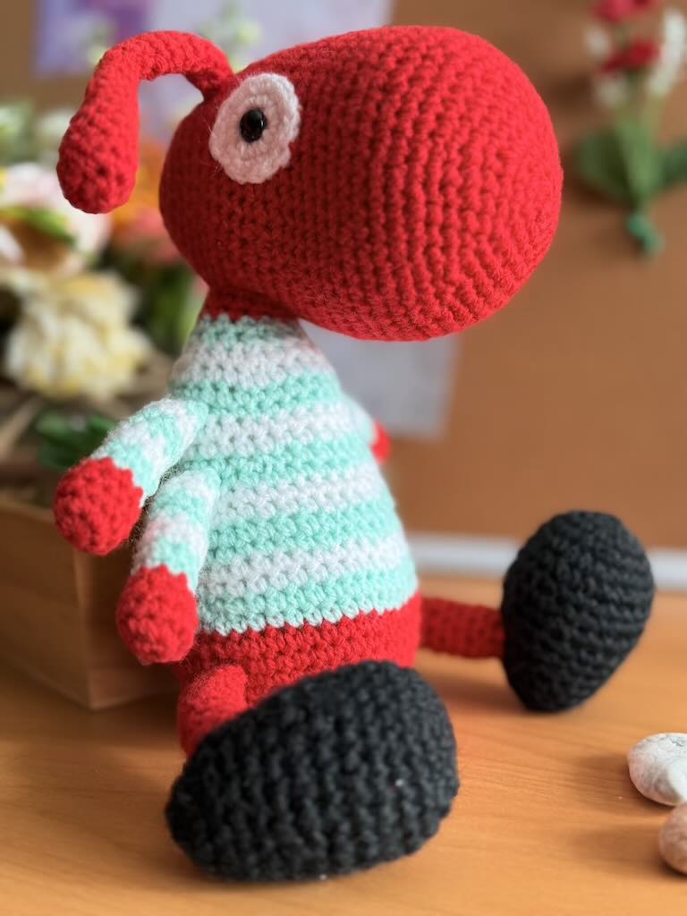 handmade crochet worker ant toy named Antony with tiny legs and stripey jumper