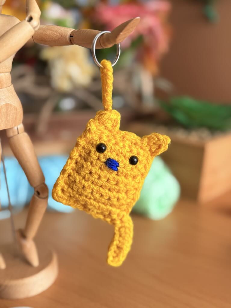 keychain handmade crochet yellow cat with playful expression