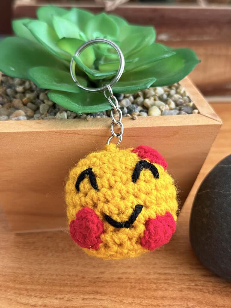 crochet keychain heart smile emoji with cheerful expression