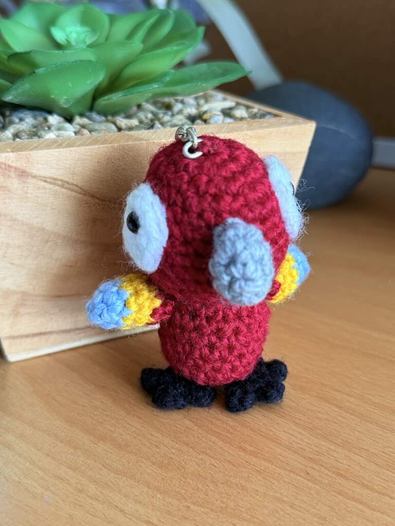 keychain crochet macaw toy with bright, colorful feathers