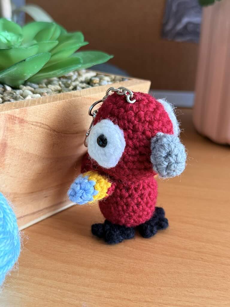 keychain crochet macaw toy with bright, colorful feathers