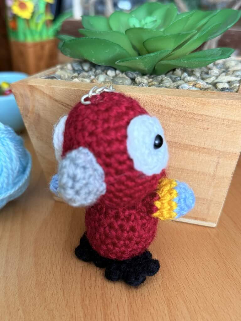 keychain crochet macaw toy with bright, colorful feathers