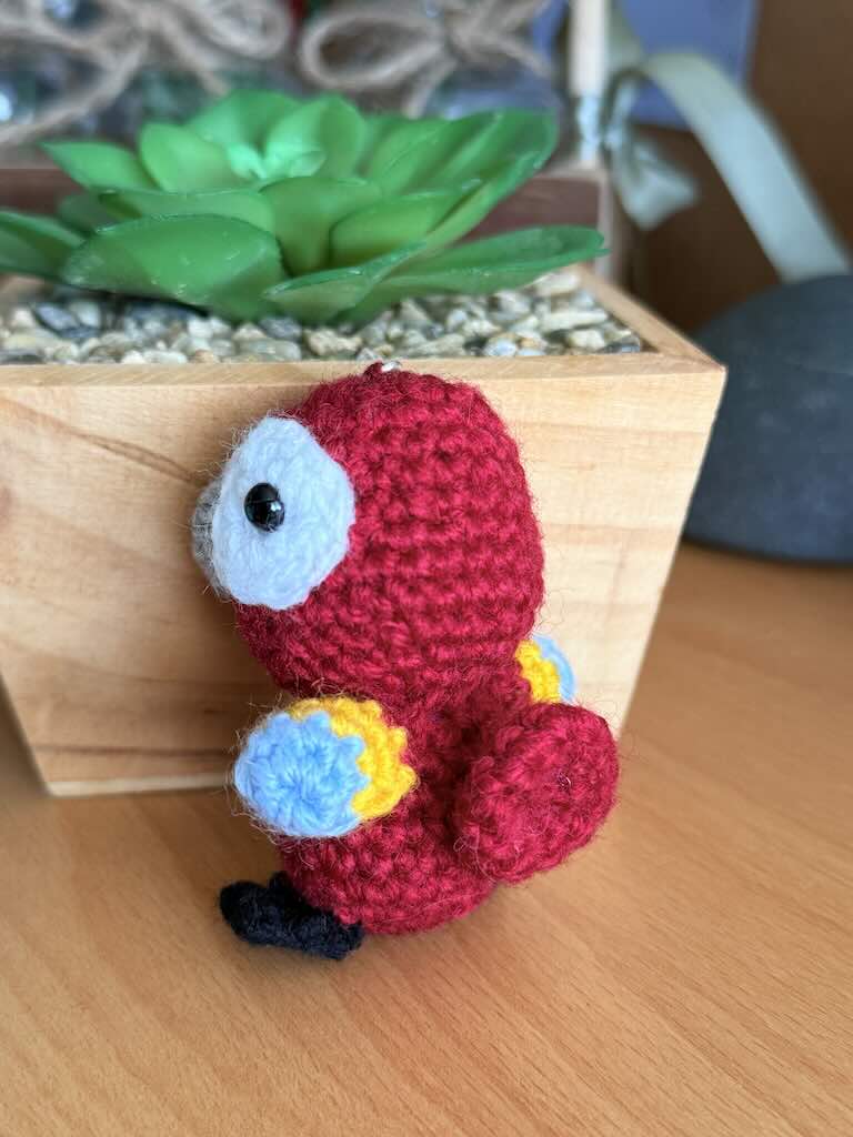 keychain crochet macaw toy with bright, colorful feathers