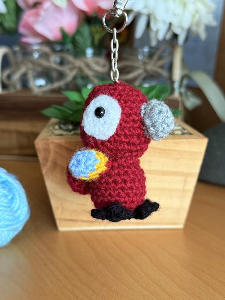 keychain crochet macaw toy with bright, colorful feathers