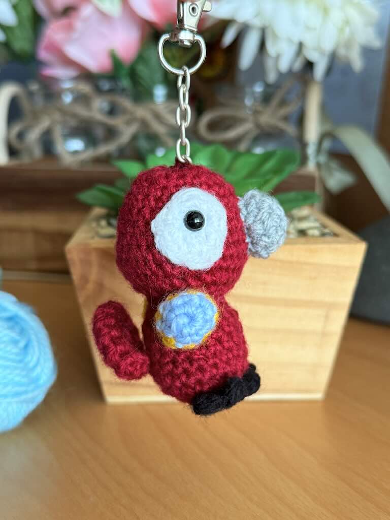 keychain crochet macaw toy with bright, colorful feathers