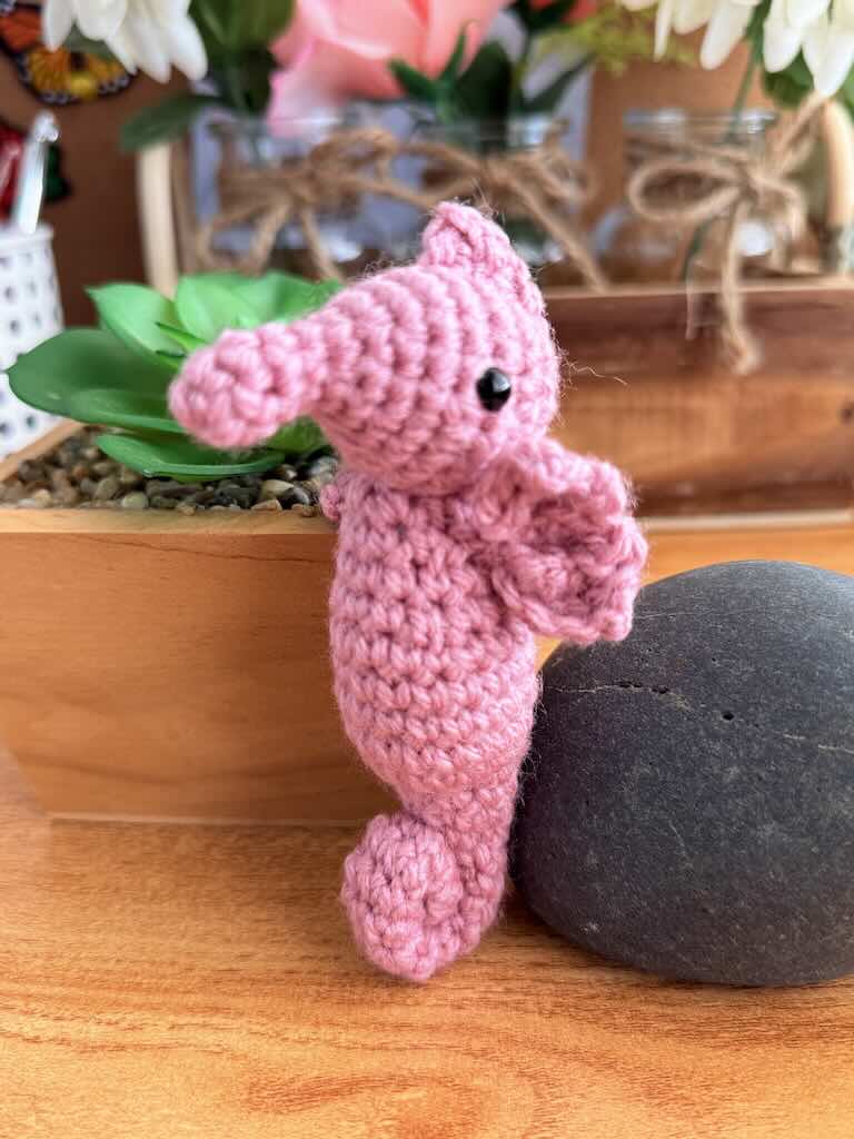 handmade crochet seahorse toy named Saul with curly tail and delicate pink fins