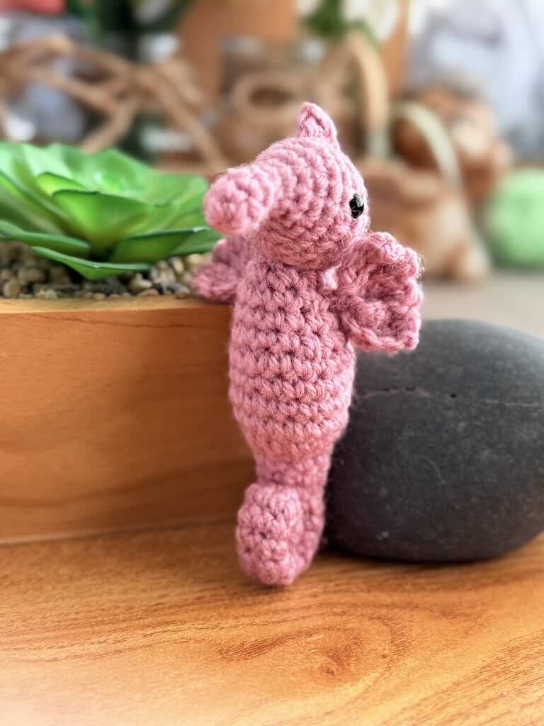 handmade crochet seahorse toy named Saul with curly tail and delicate pink fins
