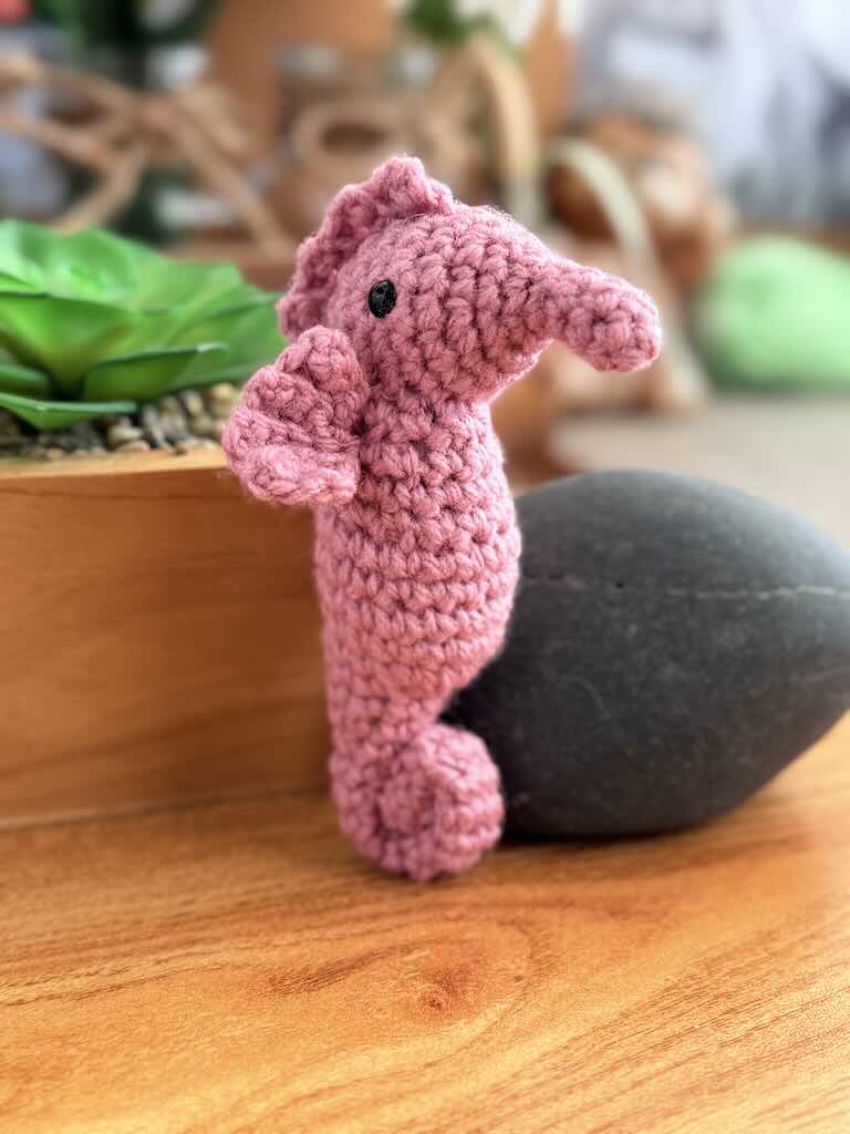 handmade crochet seahorse toy named Saul with curly tail and delicate pink fins