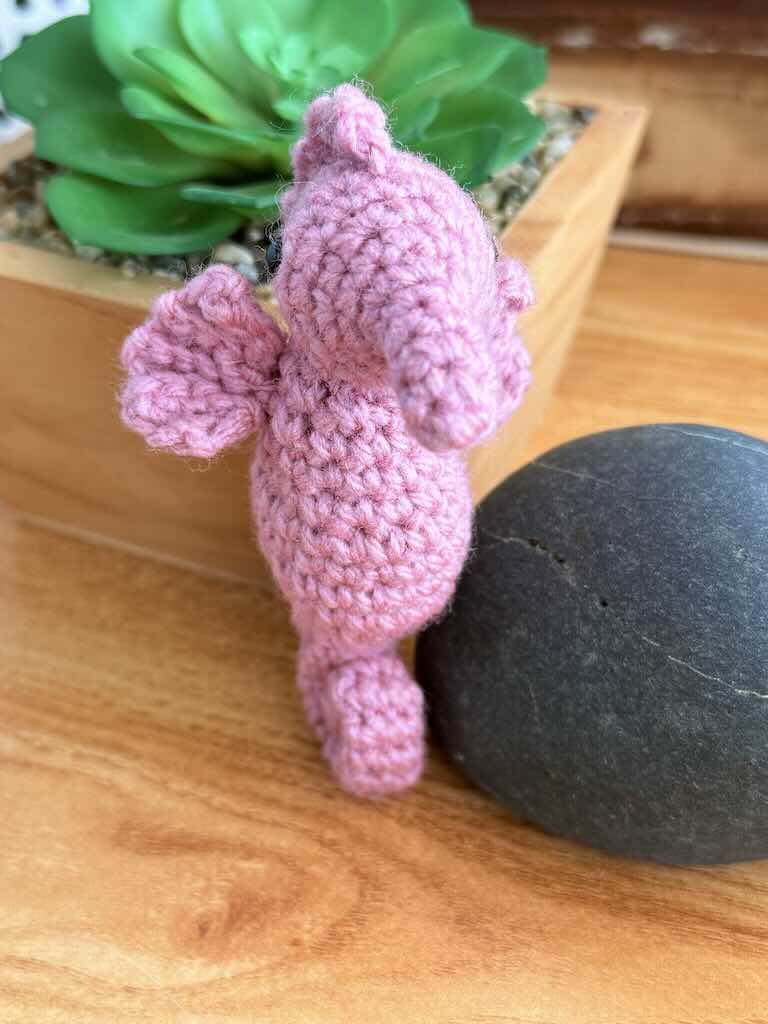 handmade crochet seahorse toy named Saul with curly tail and delicate pink fins