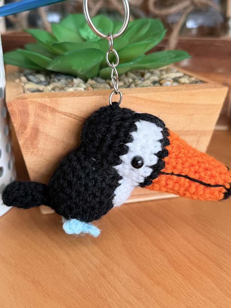 keychain crochet toucan toy with bright orange beak and black feathers