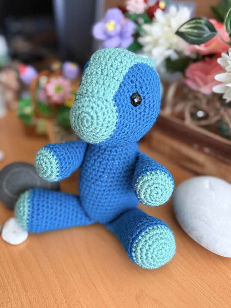 handmade crochet blue Parasaurolophus dinosaur named Peter with curved crest
