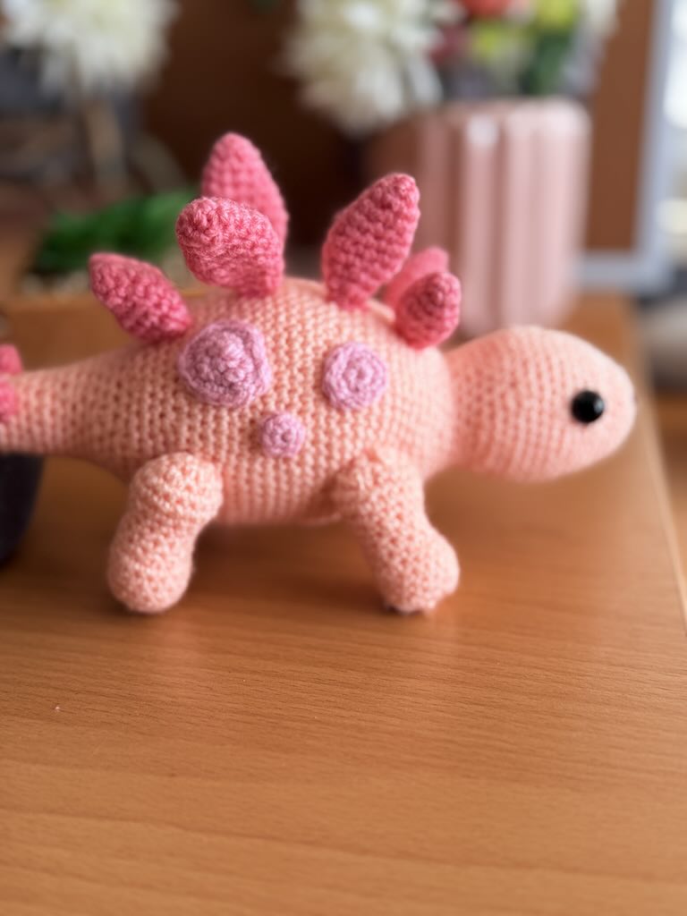 handmade crochet stegosaurus dinosaur toy named Simon with plated back
