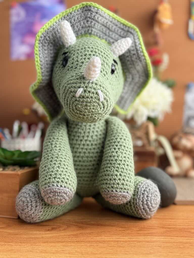 handmade crochet triceratops dinosaur toy named Trixie with three horns