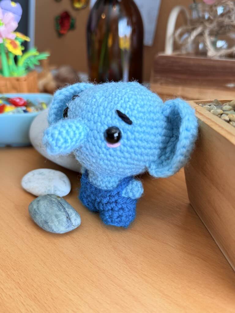 handmade crochet cute baby elephant toy named Bluey with blue dungarees