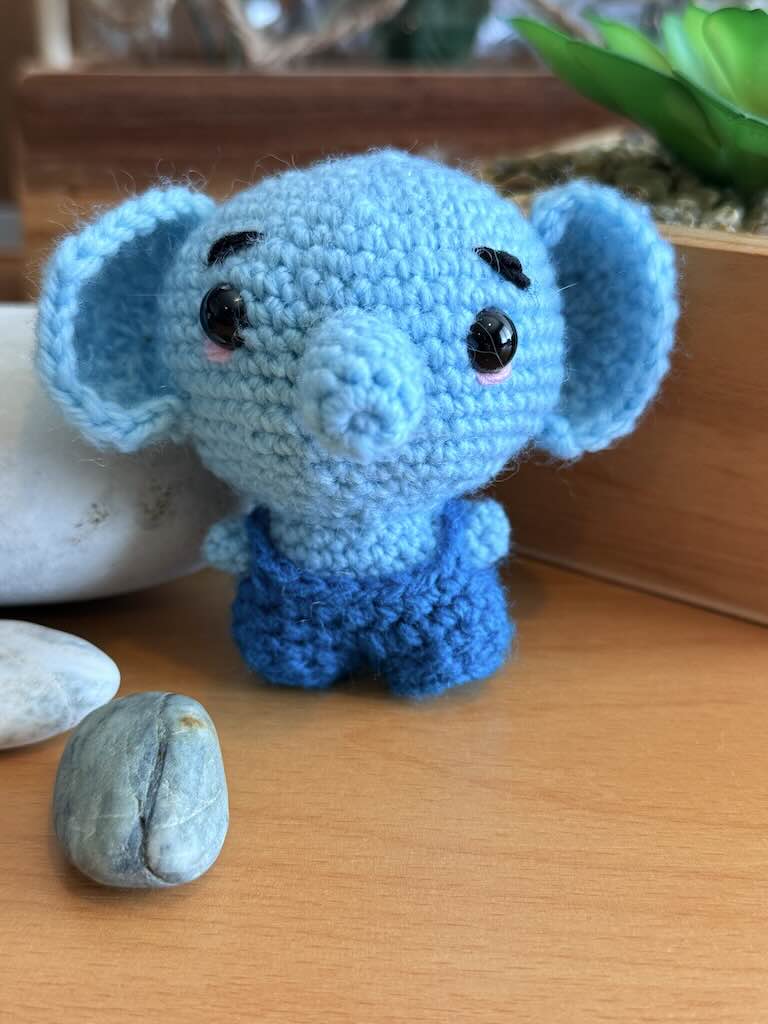 handmade crochet cute baby elephant toy named Bluey with blue dungarees