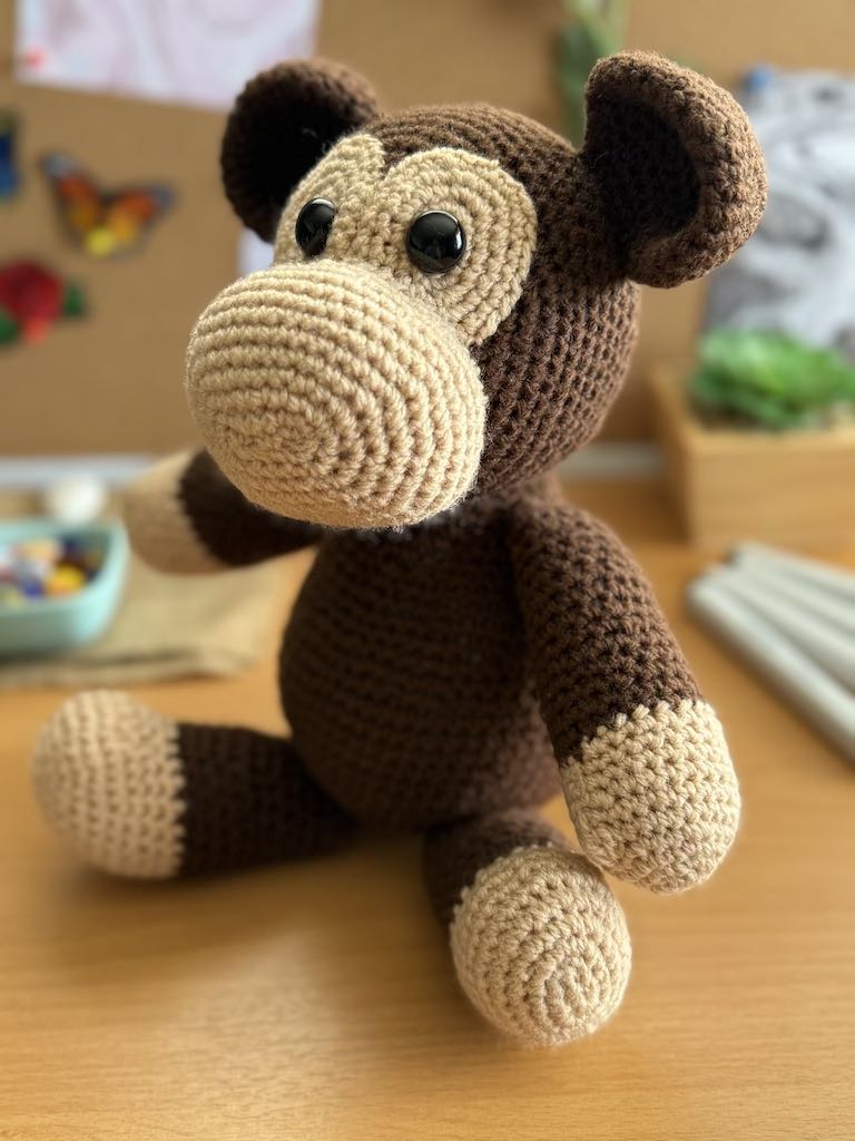 handmade crochet monkey toy named Minkie with soft brown yarn