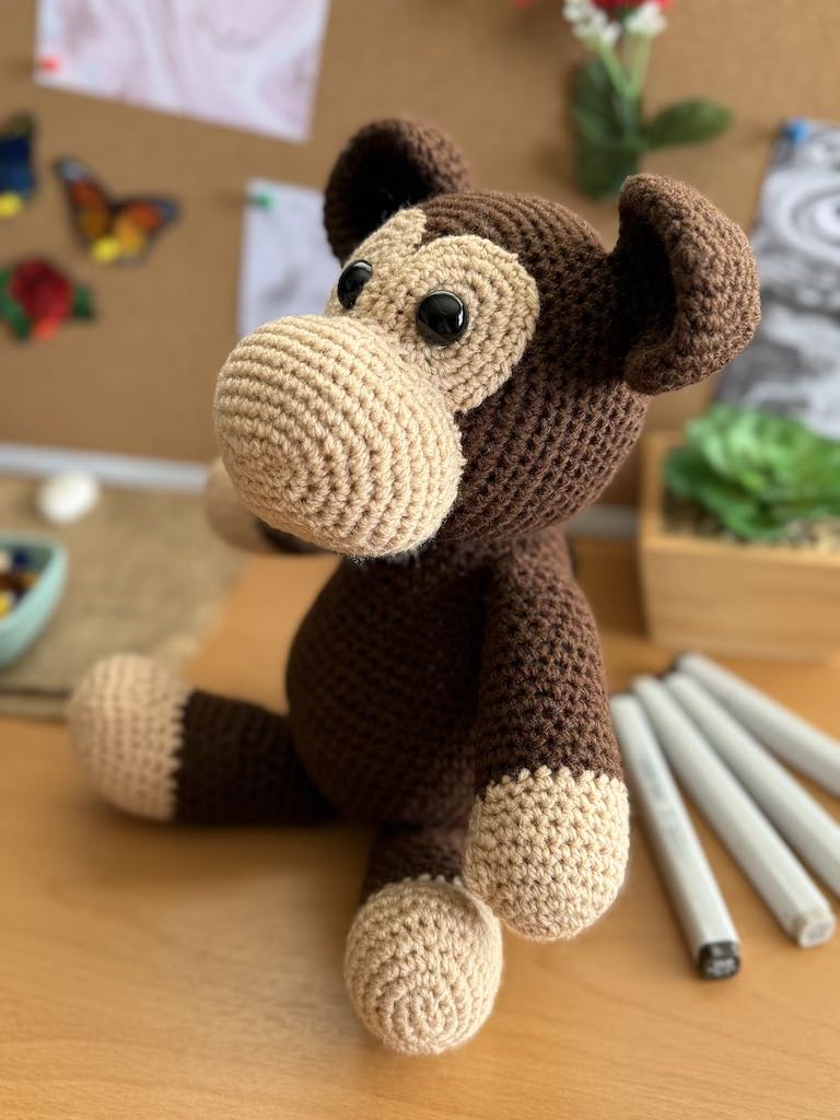 handmade crochet monkey toy named Minkie with soft brown yarn