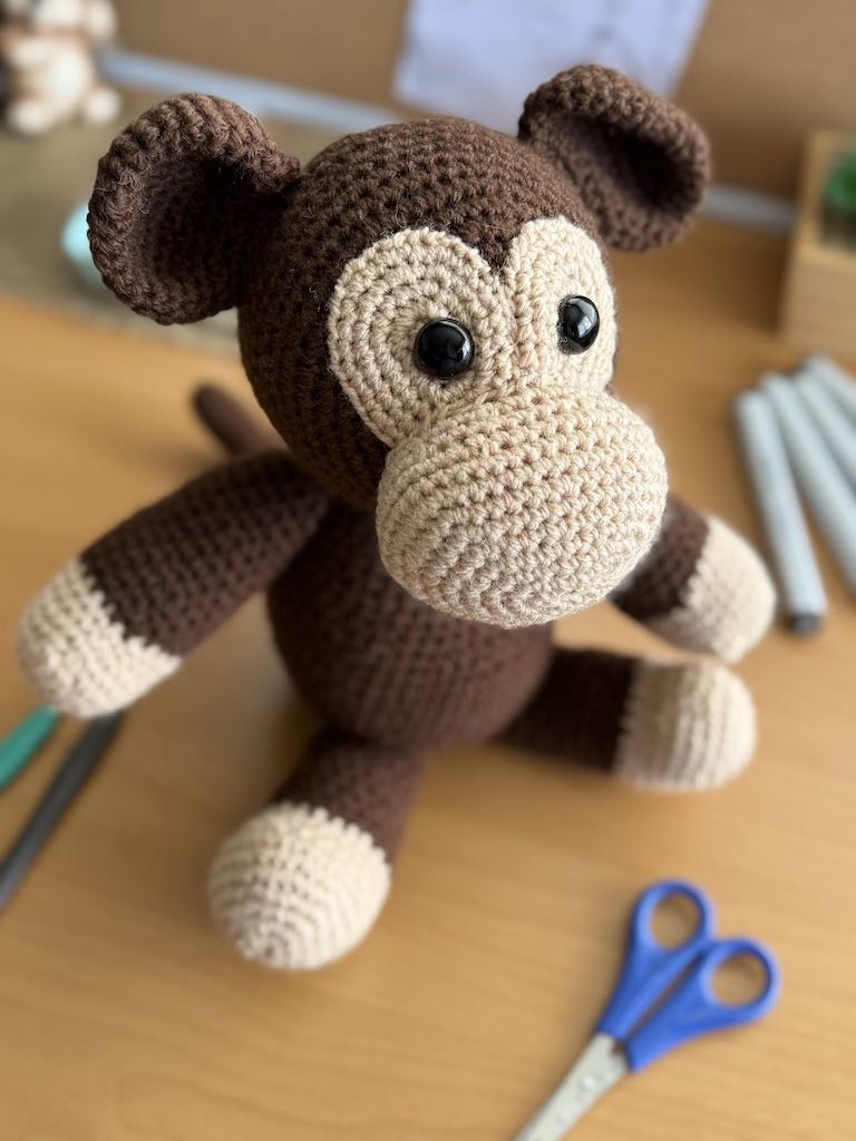 handmade crochet monkey toy named Minkie with soft brown yarn