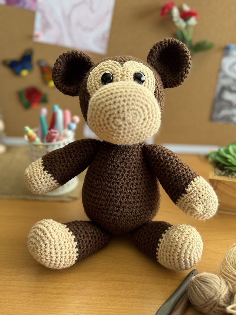 handmade crochet monkey toy named Minkie with soft brown yarn