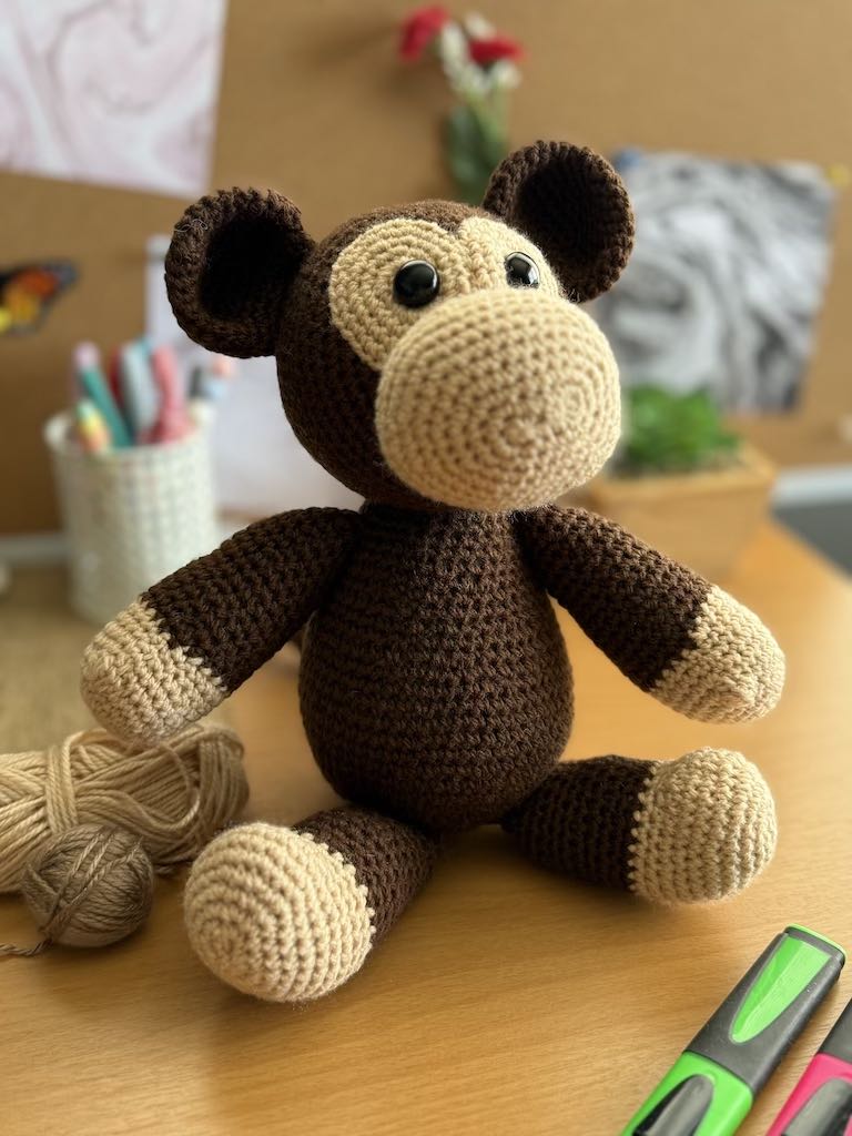 handmade crochet monkey toy named Minkie with soft brown yarn