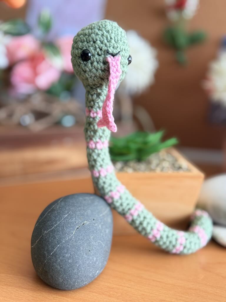 handmade crochet snake toy named Slither with long body and playful face