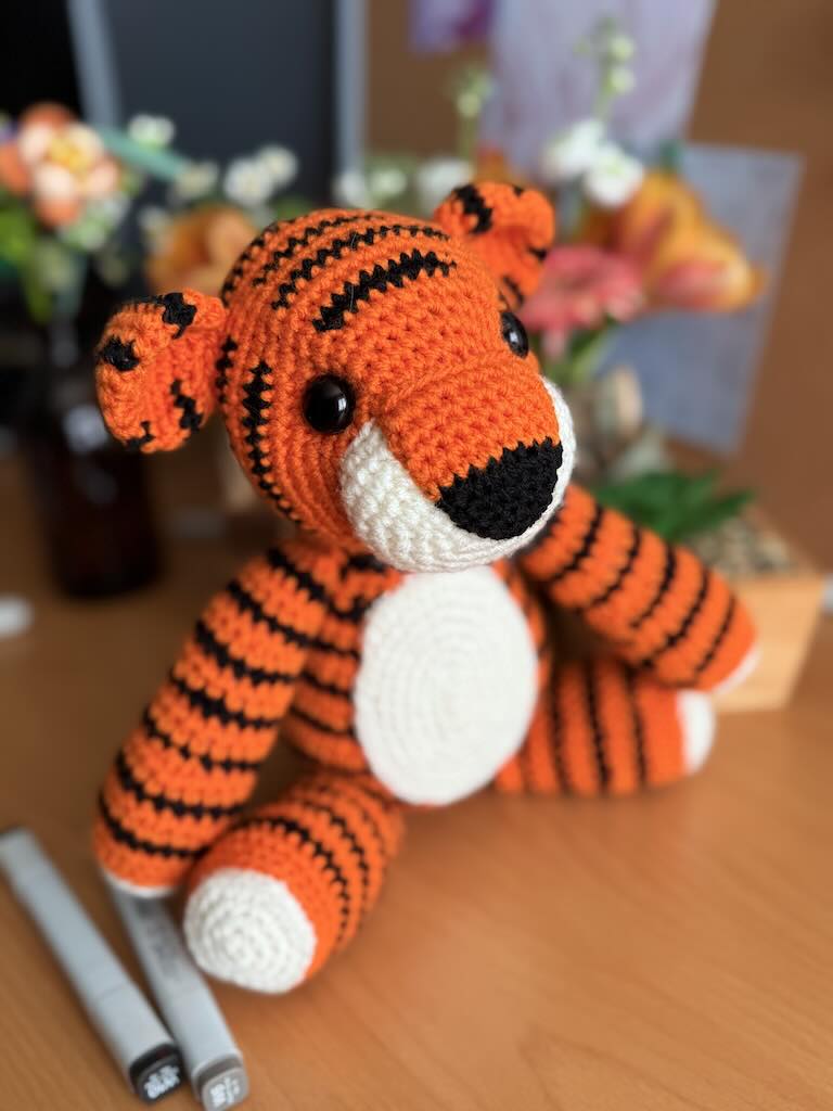 handmade crochet tiger toy named Tommy with orange and black stripes