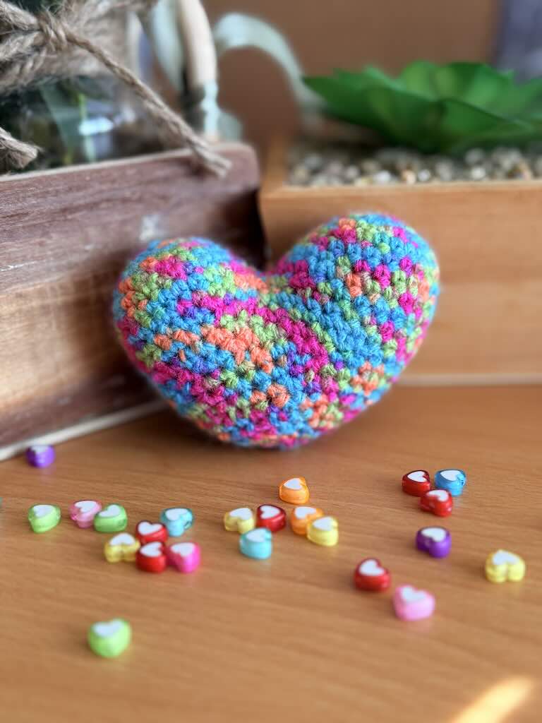 handmade crochet heart with multiple bright colours and playful design