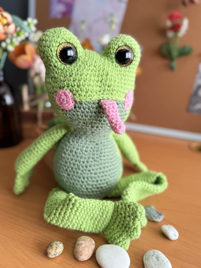 handmade crochet frog toy named Flipper with big eyes and pink tongue