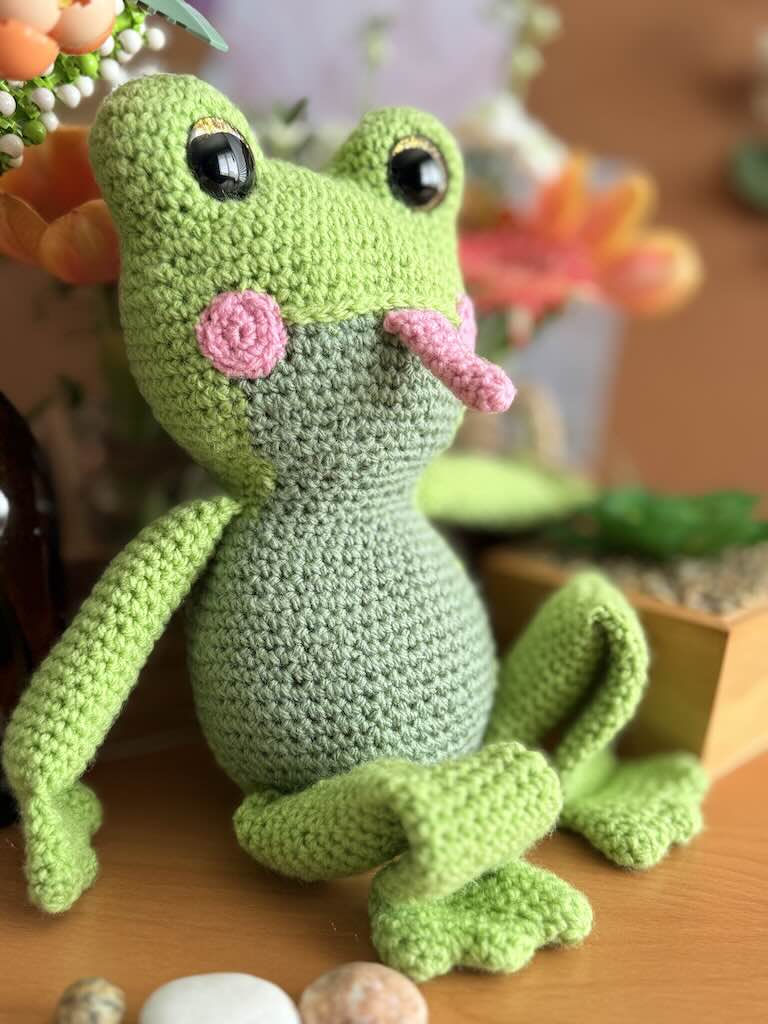 handmade crochet frog toy named Flipper with big eyes and pink tongue