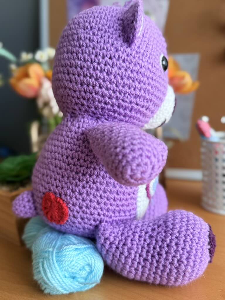 handmade crochet purple bear toy named Carrie inspired by Care Bears with cheerful look