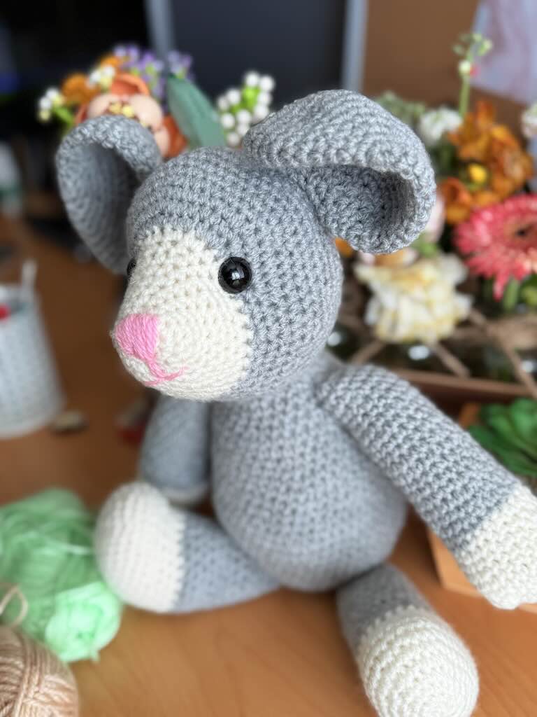 handmade crochet mouse toy named Mindy with tiny ears and pink nose