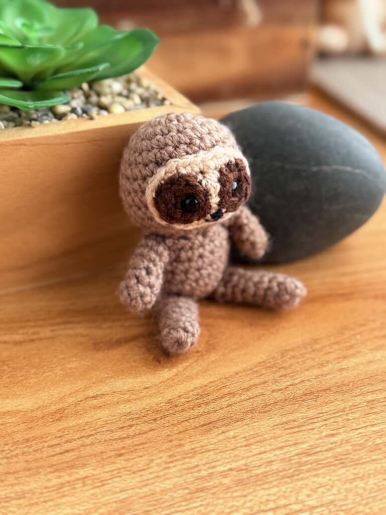 handmade crochet sloth toy named Spud with cozy yarn and lazy charm