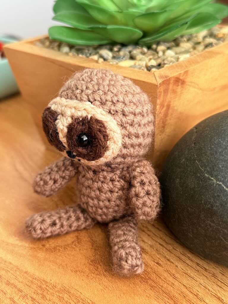 handmade crochet sloth toy named Spud with cozy yarn and lazy charm