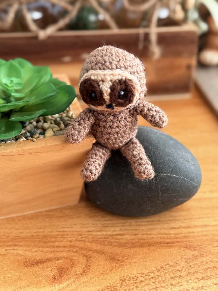 handmade crochet sloth toy named Spud with cozy yarn and lazy charm