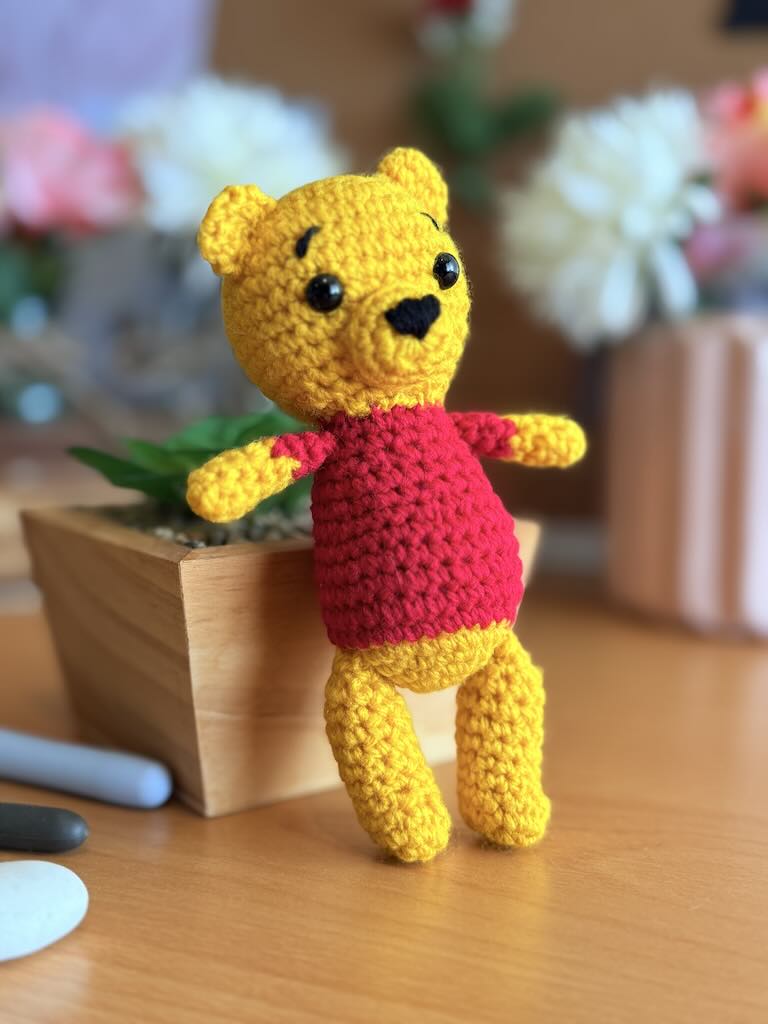 handmade crochet bear toy inspired by Winnie the Pooh with red shirt and warm smile