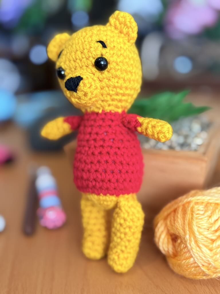 handmade crochet bear toy inspired by Winnie the Pooh with red shirt and warm smile